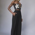 Blonde bob wig styled on a woman with a strapless top and wide-leg pants.
